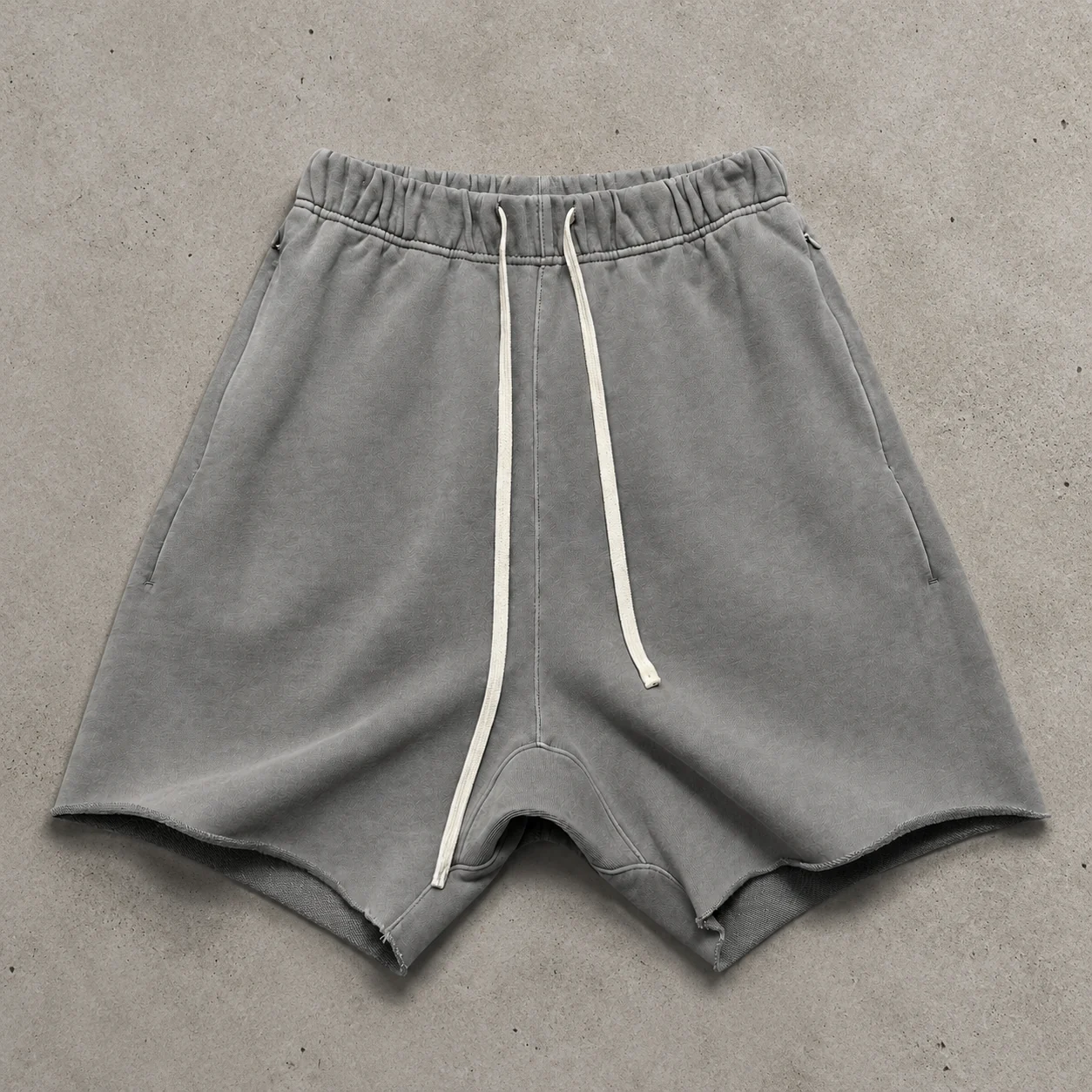 Garment detail flat lay on cement