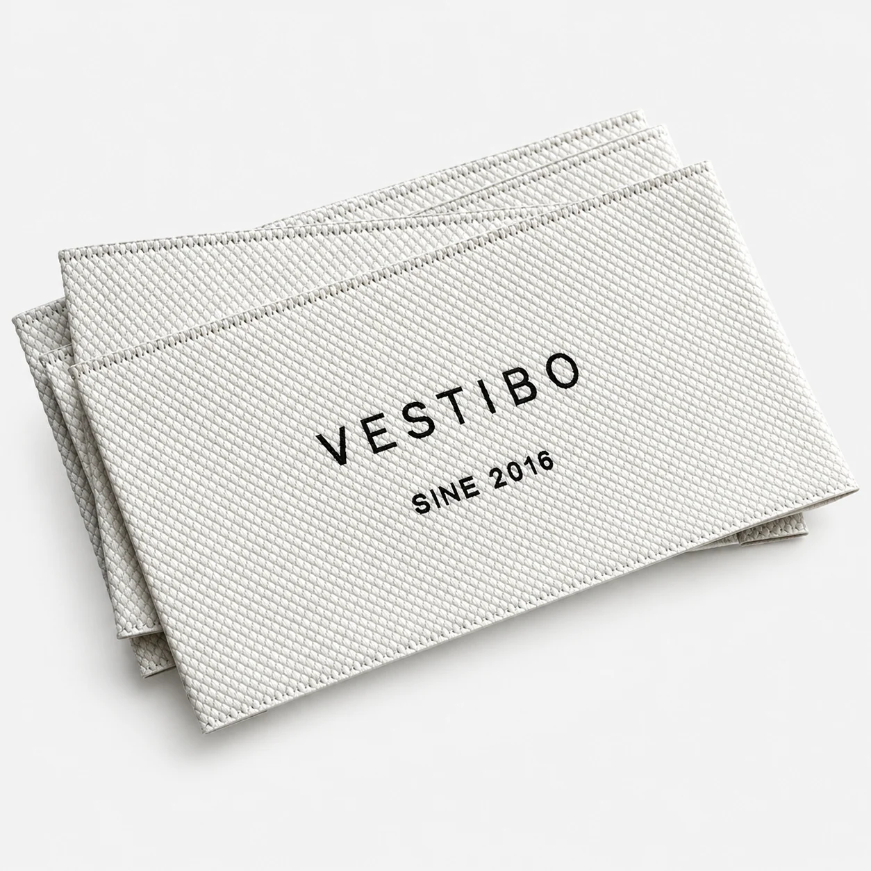 White woven main label with black lettering