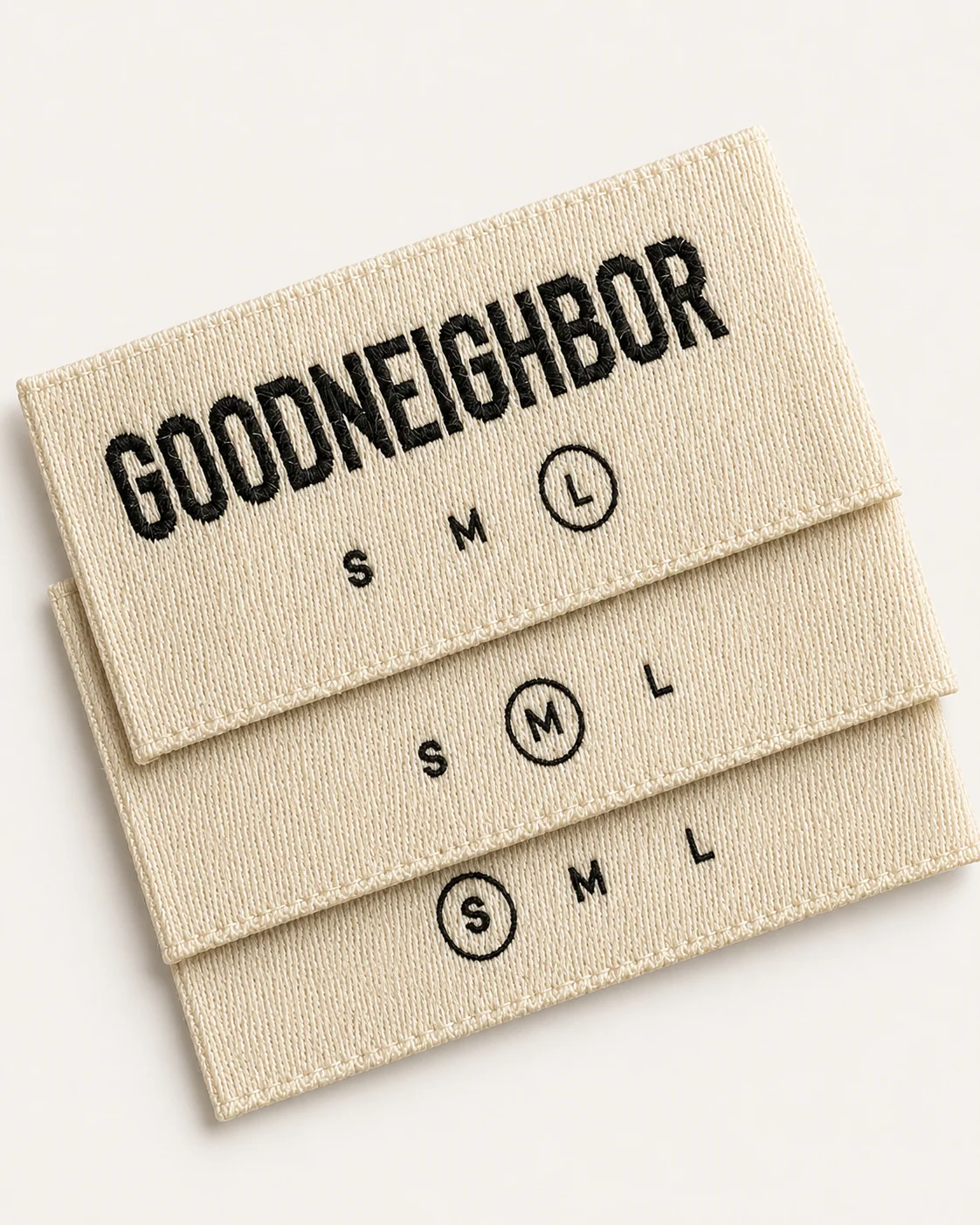 Cream woven labels displaying size marks